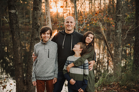dad gets hugs from his three kids