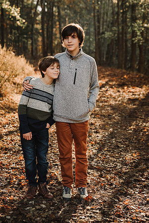 brothers hug in a forest
