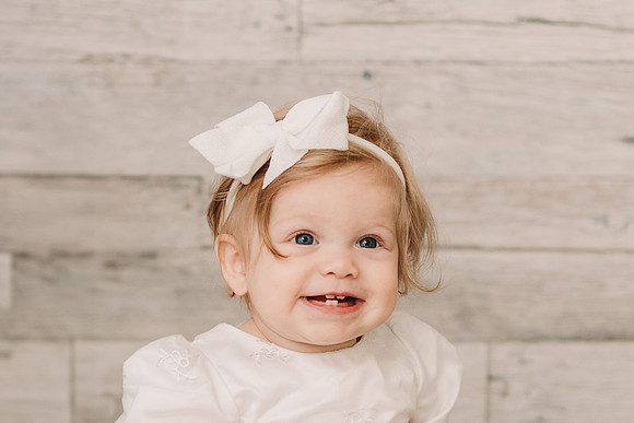 smiling portrait of a one year old girl