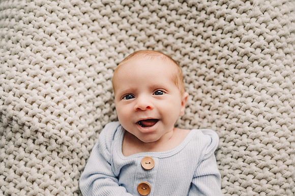 smiling newborn baby boy